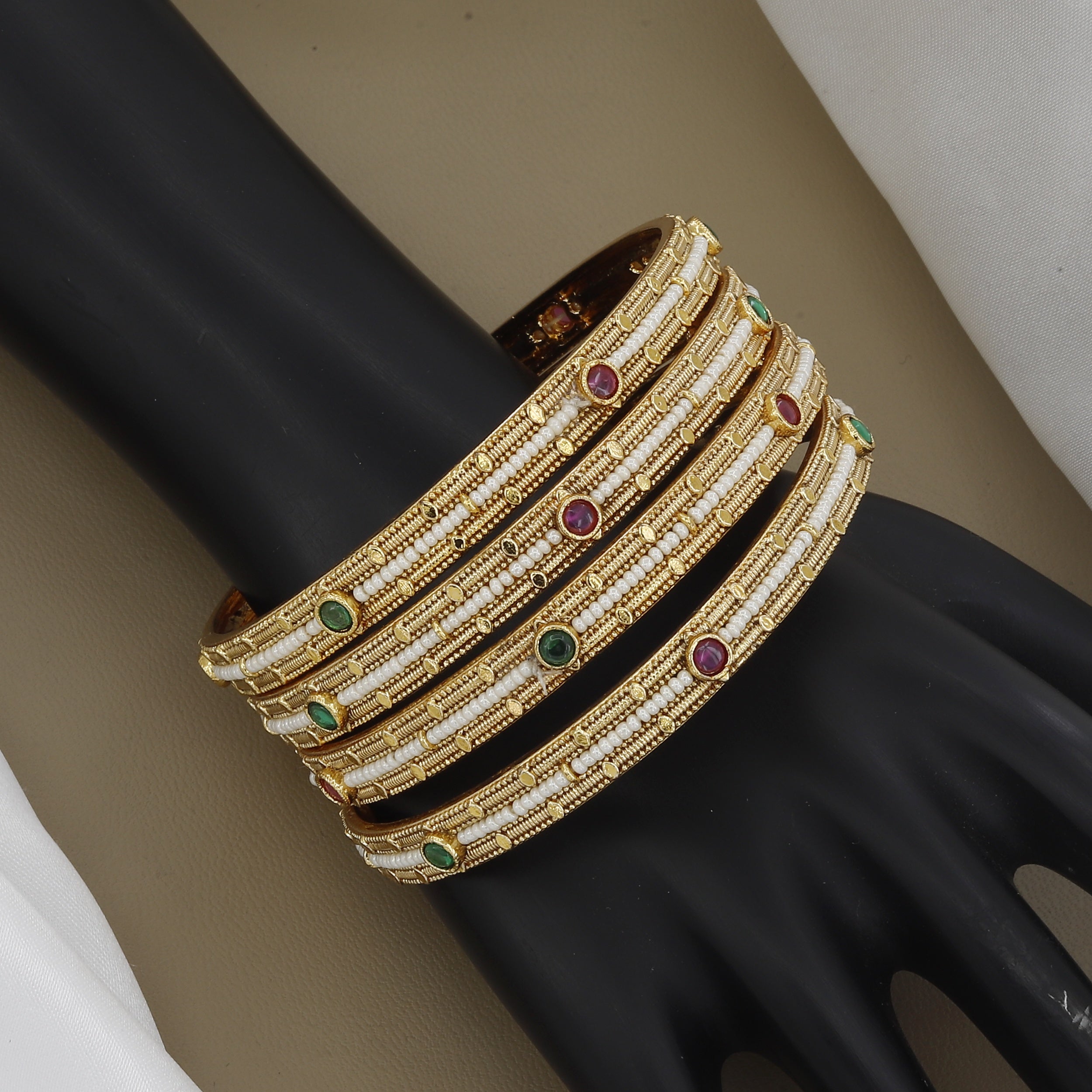 Elegant Pearl Beaded Gold Toned Bangle Set with Kundan Stones