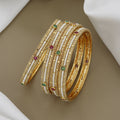 Elegant Pearl Beaded Gold Toned Bangle Set with Kundan Stones