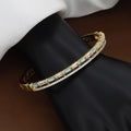Luxurious Gold Double-Row Bangle with Baguette Crystals & White Inlay