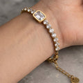 Gold Tennis Bracelet with Emerald Cut Center Stone
